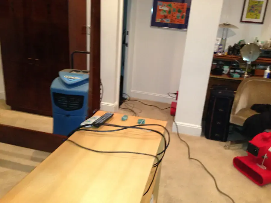 Dehumidifier and air mover drying a water-damaged room in a Hayward home