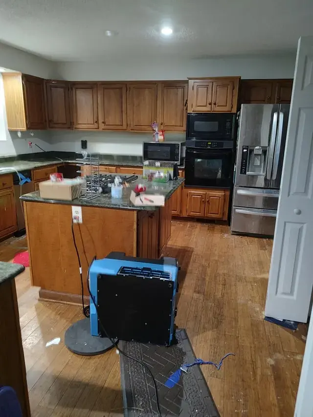 Dehumidifier drying a kitchen with hardwood floors after a leak in Hayward