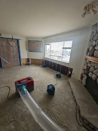 Air movers and ducted drying along a living room wall with the flooring pulled in Hayward