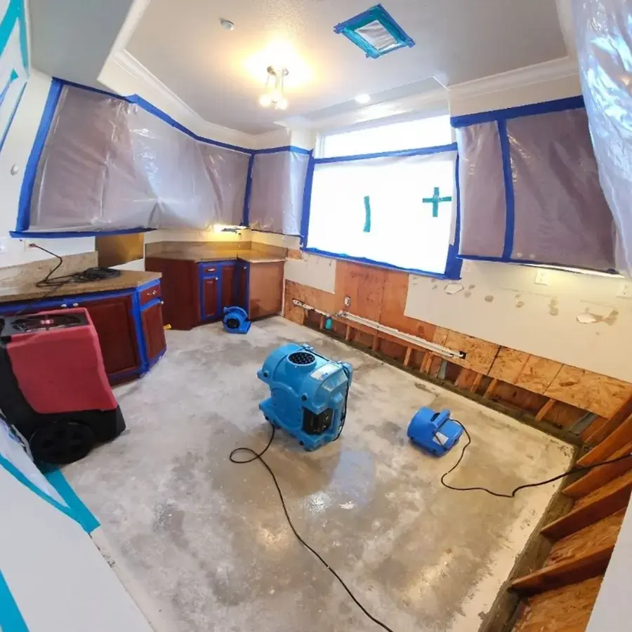 Containment, air movers and a dehumidifier drying a stripped kitchen in Hayward